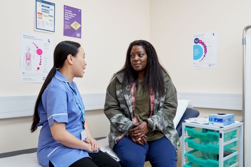 Photo showing a nurse speaking to a patient about cervical screening