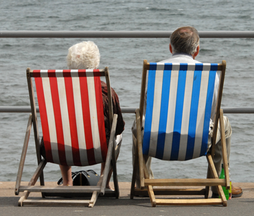 Photograph of couple sitting on deckchairs